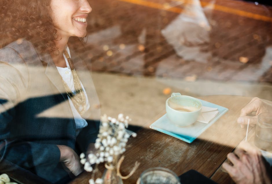 Culture: Woman laughing at coffee shop